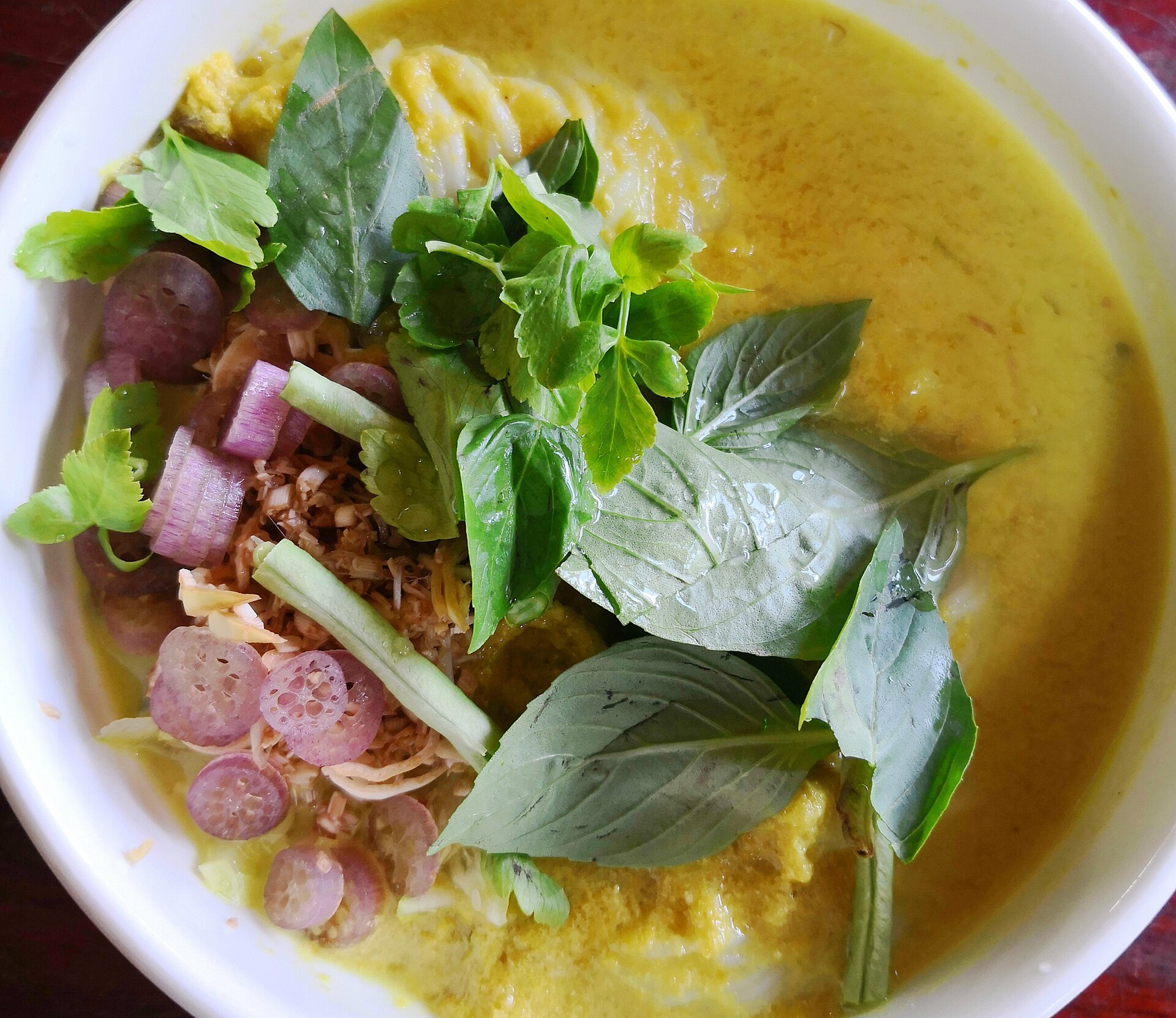 Nom banh chok with rice noodles, fish gravy, and fresh herbs